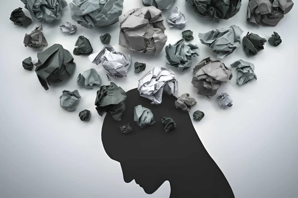 Silhouette of a person with crumpled paper representing overwhelming anxiety symptoms and mental stress